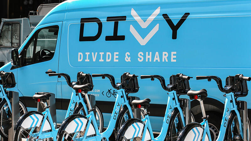 Divvy vans and bikes with logo decal on blue van
