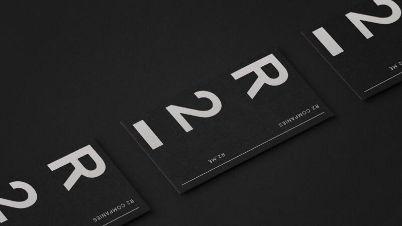 R2 logo printed white on a series of black business cards