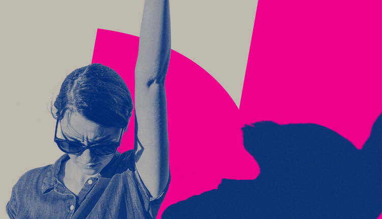 Individual woman looking strong wearing sunglasses with arm raised into the air on a pink and blue background