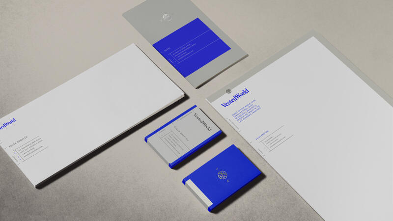 Vested World envelopes, business cards, letterhead and small booklet featuring logo and brand colors